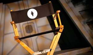 Director's chair with a woman symbol. From ARTINFO's "Twelve Female Directors That Are Reshaping American Theater"